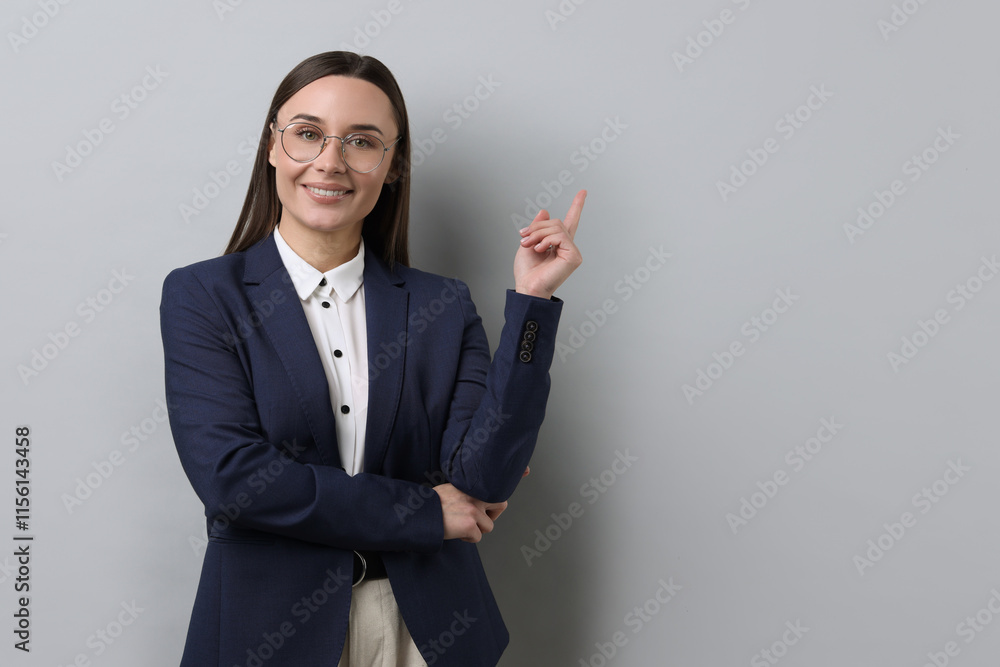 Portrait of businesswoman in glasses on light grey background, space for text Portrait of businesswoman in glasses on light grey background, space for text