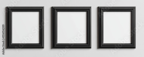 Three black square frames on a light gray wall.