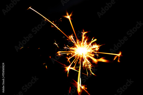 A sparkler is a type of hand held firework that burns slowly while emitting bright colored sparks photo