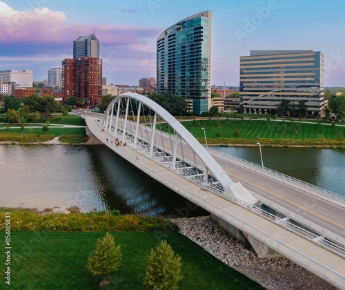 Aerial view of the modern, arched bridge over the river, with city skyline in the background. Pedestrians on the bridge, and office buildings. MAIN ST. BRIDGE, COLUMBUS, OHIO, UNITED STATES photo