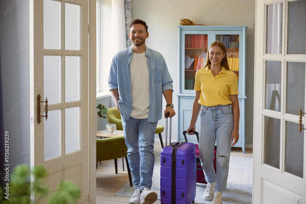 © Nomad_Soul - Young man and woman couple leaving home with packed travel suitcase