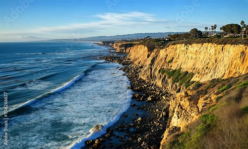 Dramatic Coastal Cliffs and Ocean Waves at Sunset photo