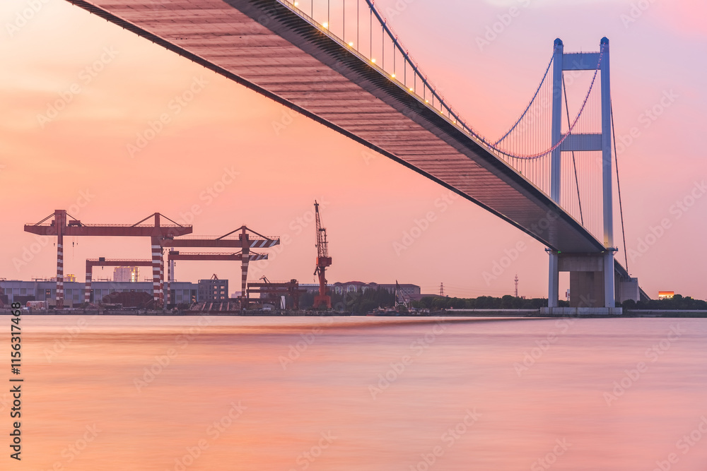 Fototapeta premium Jiangyin Yangtze River Bridge and the beautiful scenery of the Yangtze River and sunset in Jiangsu Province, China on August 20, 2024