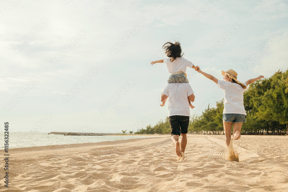 Happy family in holiday. Father, Mother and kids having fun together shoulder ride and running on summer beach, Parents carrying children on neck, family is enjoying their summer in sunset time Happy family in holiday. Father, Mother and kids having fun together shoulder ride and running on summer beach, Parents carrying children on neck, family is enjoying their summer in sunset time