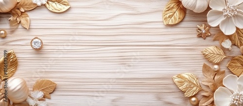 Autumn fashion accessories arrangement featuring golden leaves and floral elements on wooden surface with space for text