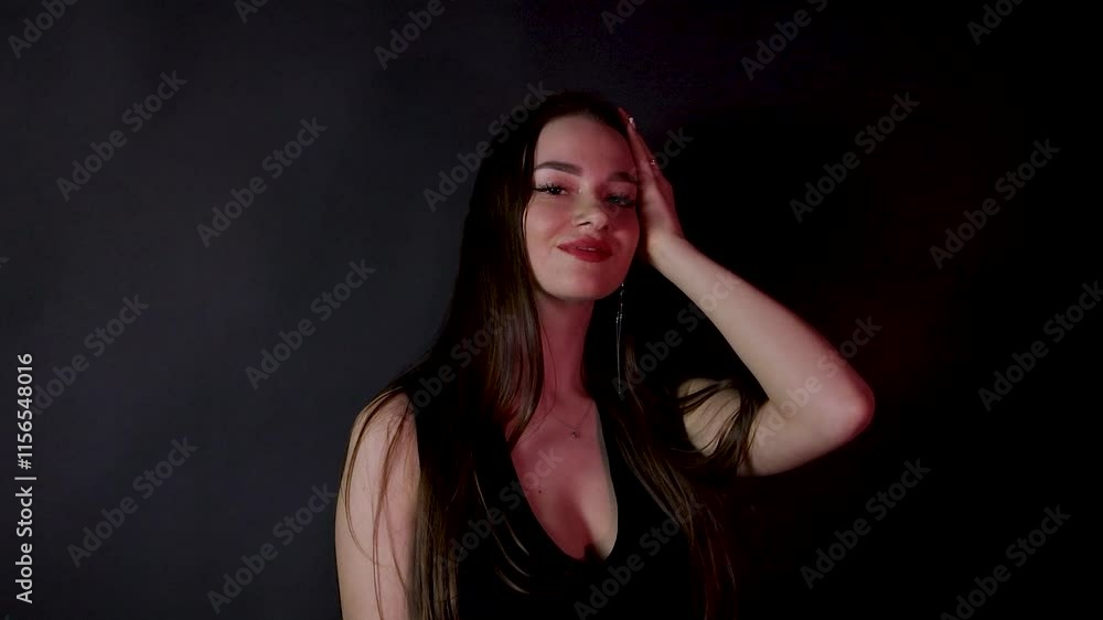 Sexy fashion model posing alone dressed in black dark studio red light Sexy fashion model posing alone dressed in black dark studio red light