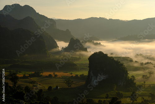 The mountains are covered in fog and the sky is a mix of blue and orange Phu Langka Phayao ,thailand photo