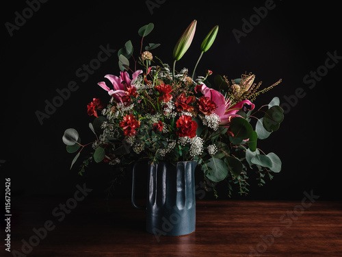 Wallpaper Mural Beautiful bouquet of flower and leaf arrangement in a vase moody isolated in a dark room on a wooden table Torontodigital.ca