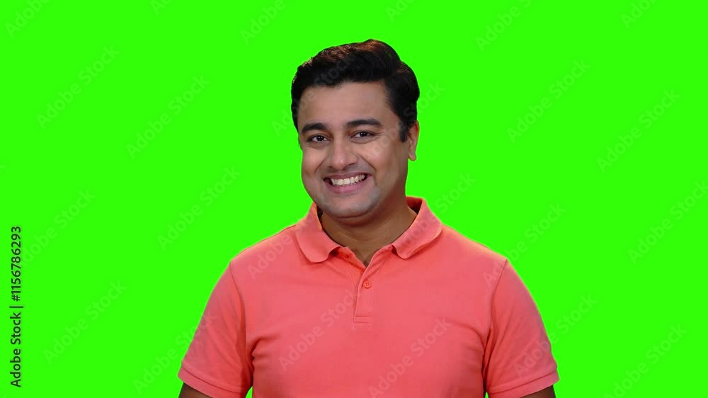 A young male model smiling and giggling in a green screen studio. A happy and positive person. A young male model smiling and giggling in a green screen studio. A happy and positive person.