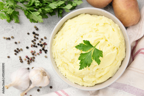 Mashed potatoes in white bowl on grey concrete background. Healthy food