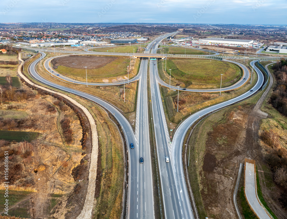 Modlnica interchange on S52, part of highway ring road around Krakow opened on December 23, 2024. Multilevel junction with viaducts, enter and exit ramps and traffic.
Aerial view in sunset light
