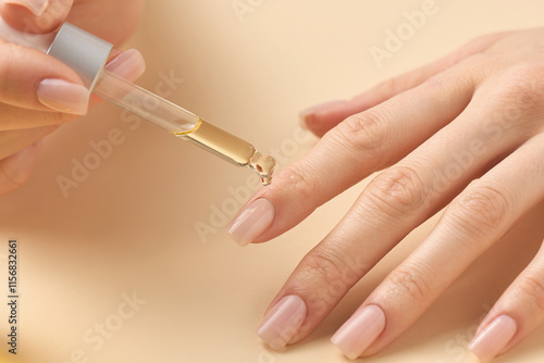 Applying nourishing oil to enhance nail health and appearance during a self-care routine at home