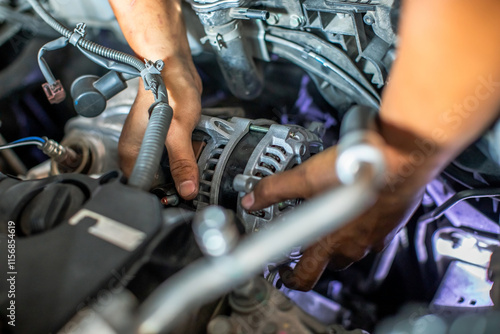 Картината върху платно Mechanic is repairing and replacing a battery charger at car service center