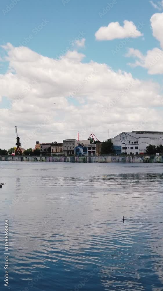 Vertical at Riachuelo Matanza river, La Boca, Coastline landscape at Buenos Aires City Argentina, ducks fly at Tango historical neighborhood Vertical at Riachuelo Matanza river, La Boca, Coastline landscape at Buenos Aires City Argentina, ducks fly at Tango historical neighborhood