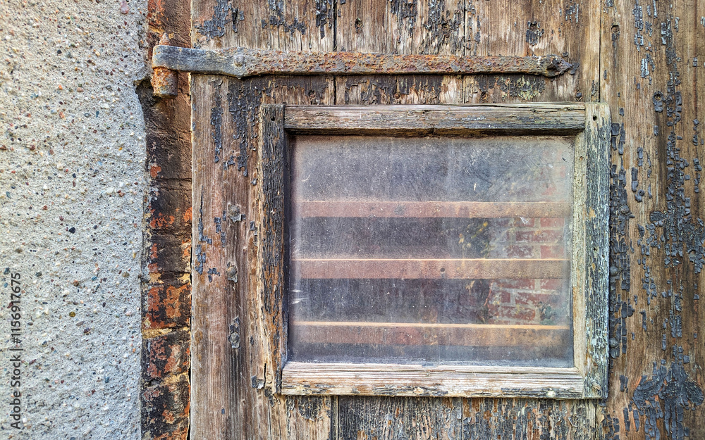 Old worn glass window on brown wooden wall. Space for your text and logo. Old worn glass window on brown wooden wall. Space for your text and logo.