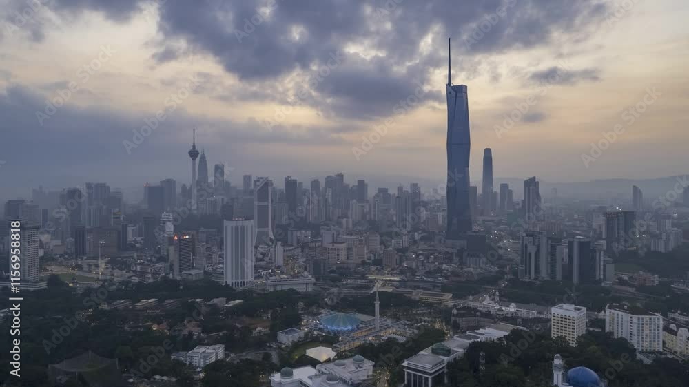 Modern skyscrapers pierce the hazy morning sky over Kuala Lumpur. Modern skyscrapers pierce the hazy morning sky over Kuala Lumpur.