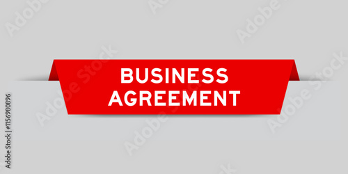 Red color inserted label with word business agreement on gray background