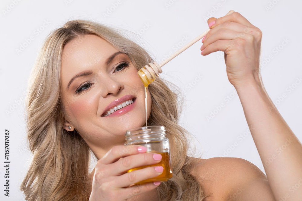 Fototapeta premium A Delicious Honey Drizzle is made even better with a Happy Smiling Woman enjoying it