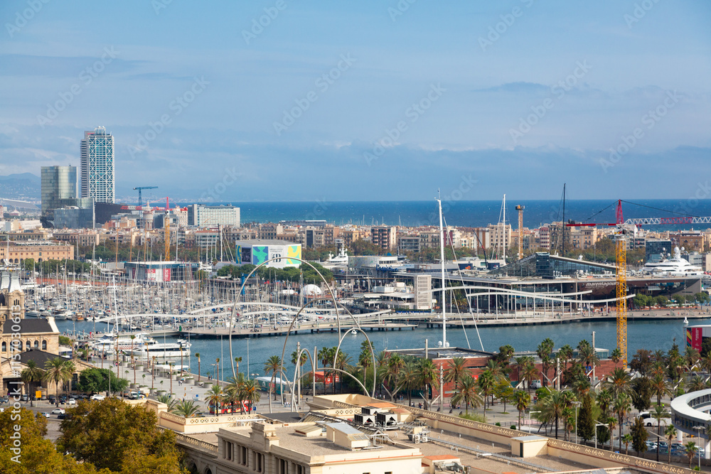 Obraz premium Modern buildings rising on barcelona's waterfront, featuring the iconic cable car tower