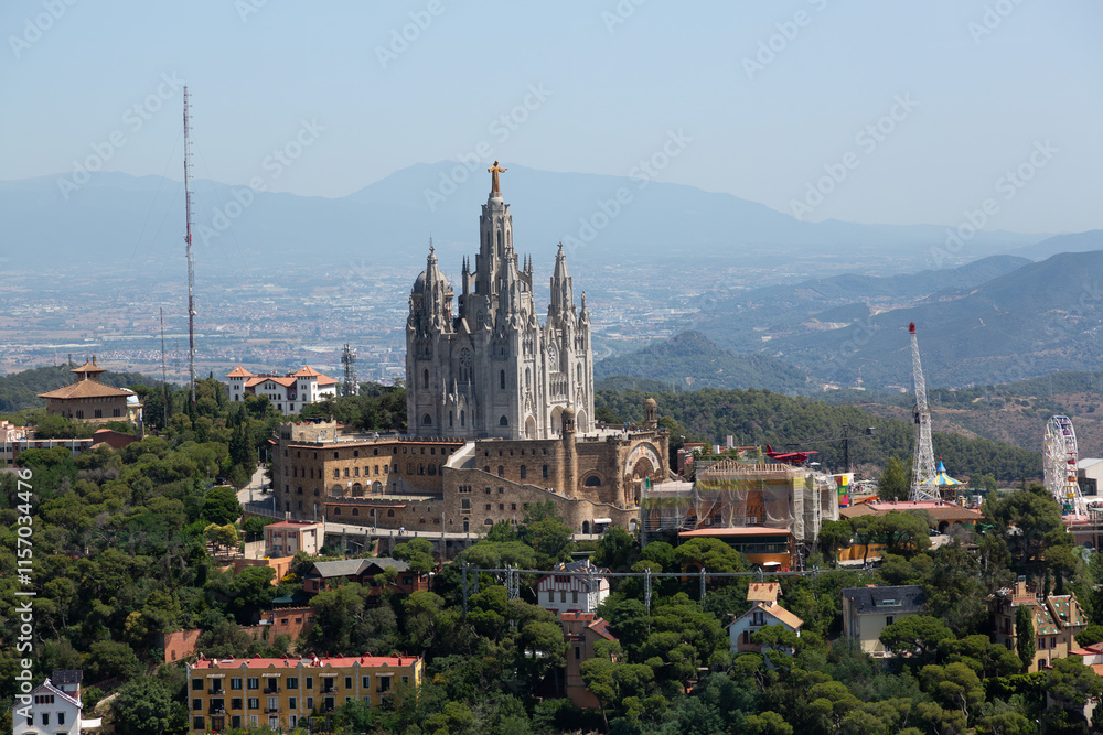 Tibidabo amusement park and expiatory church of the sacred heart of jesus dominating barcelona cityscape