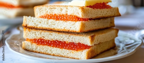 White bread sandwiches with butter and red caviar displayed elegantly on a festive celebration table setting photo