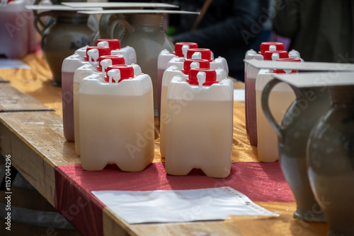 Autumn wine festival in Schengen, Luxembourg on Moselle river valley, tasting of federweisser young wine, neuer wein fermented freshly pessed auxerrois grape juice, or must. photo