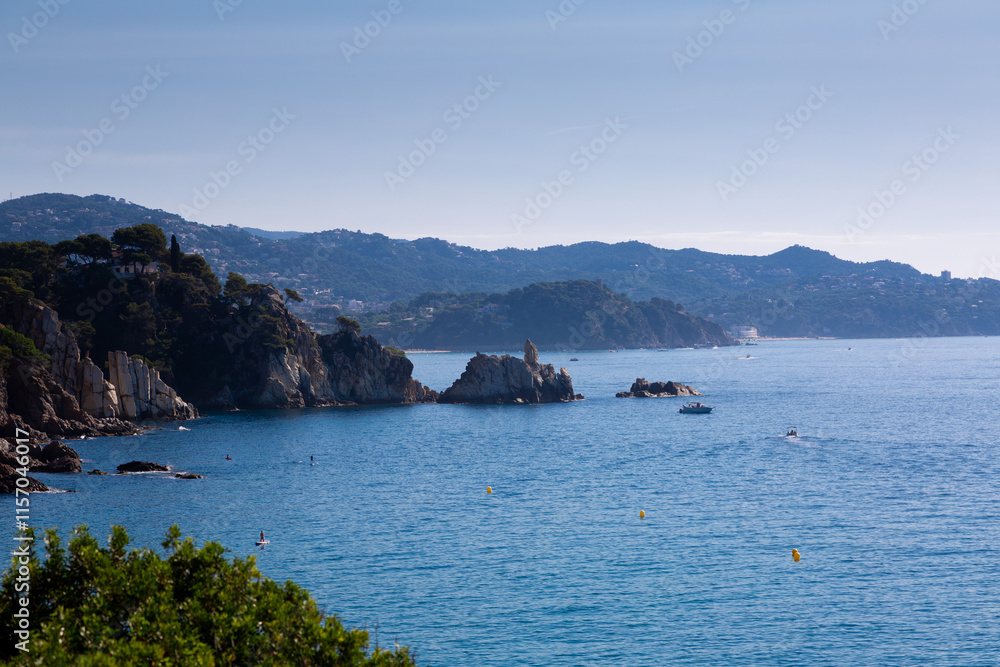 Beautiful turquoise mediterranean sea washing rocky coastline on sunny summer day