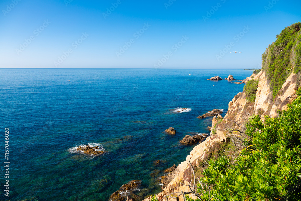 Beautiful turquoise mediterranean sea washing rocky coastline on sunny summer day