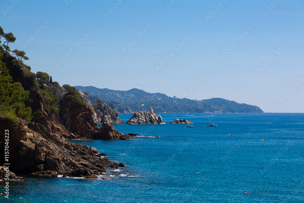 Beautiful turquoise mediterranean sea washing rocky coastline on sunny summer day