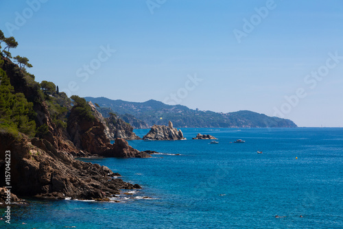 Obraz na płótnie Beautiful turquoise mediterranean sea washing rocky coastline on sunny summer day w salonie