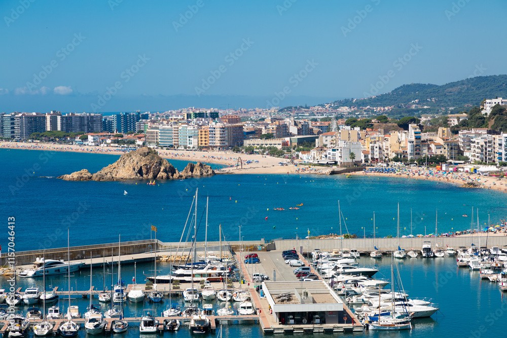 Blanes cityscape with harbor, beach and sa palomera rock in summertime