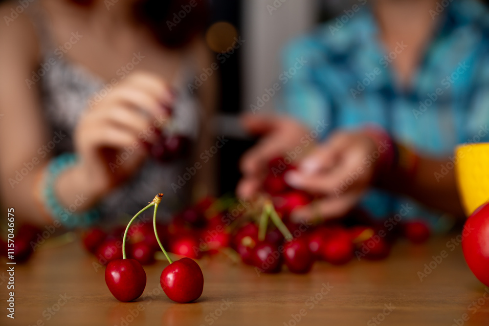 Enjoying the delightful activity of cherry picking together with good friends in a cozy setting Enjoying the delightful activity of cherry picking together with good friends in a cozy setting