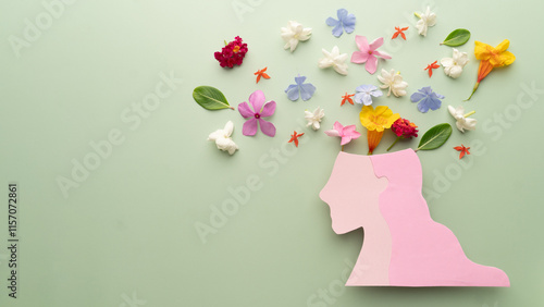 Wallpaper Mural Mental Health Awareness Month. Woman head with colorful fresh flower on green background. Peace of mind, emotional balance, positive thinking, joy and love of life concept. Torontodigital.ca