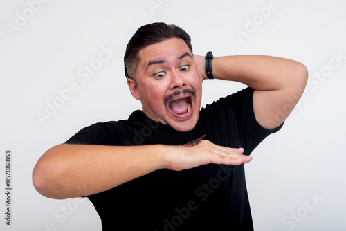 Man Reacting Fearfully to a Cockroach on His Hand, Isolated Background photo