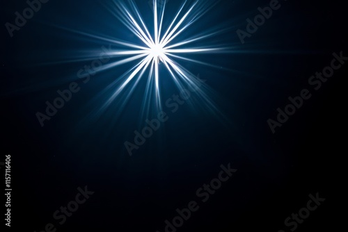 A dazzling starburst light effect featuring colorful diffraction streaks on a black surface. photo