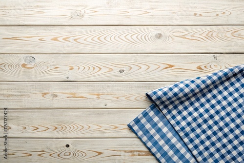Top view of a light wooden table with a blue checkered tablecloth and space for text – ideal for food bloggers, recipe creators, or businesses in the culinary and hospitality industry.