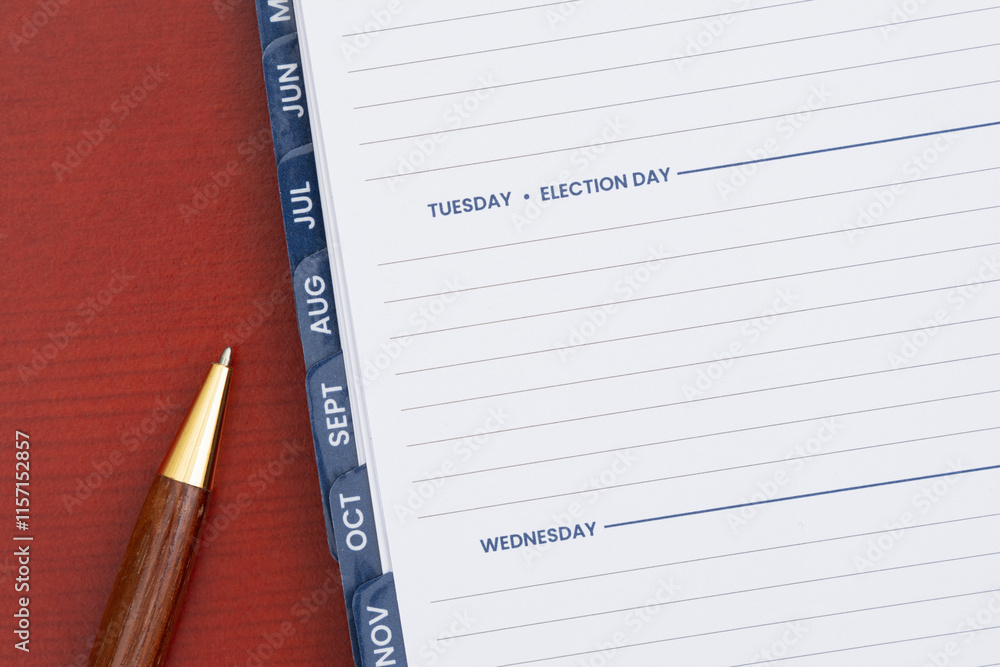 Empty day planner with Tuesday Election Day and pen on desk Empty day planner with Tuesday Election Day and pen on desk