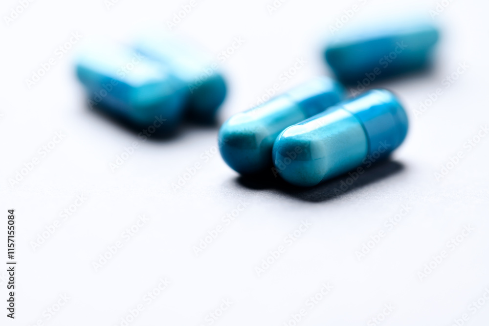Amino acids capsules on paper background. Soft focus. Close up. Copy space. Amino acids capsules on paper background. Soft focus. Close up. Copy space.