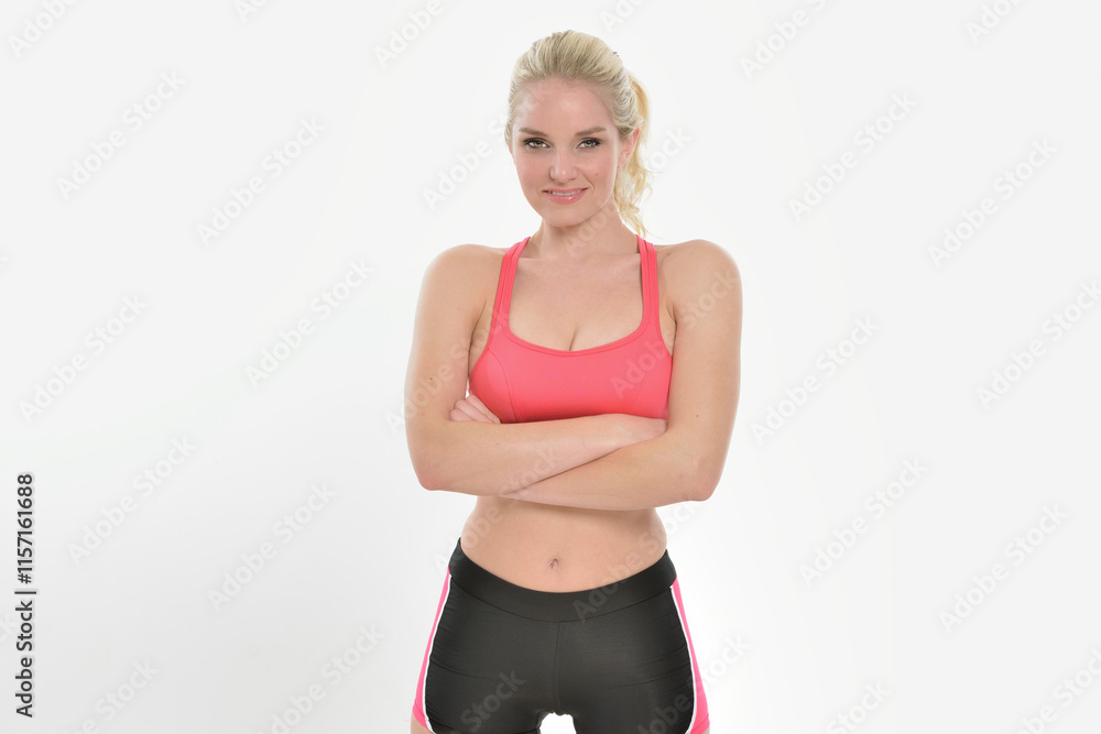 Sexy young Caucasian woman - fitness model - posing in lycra shorts and sports bra - smiling Sexy young Caucasian woman - fitness model - posing in lycra shorts and sports bra - smiling
