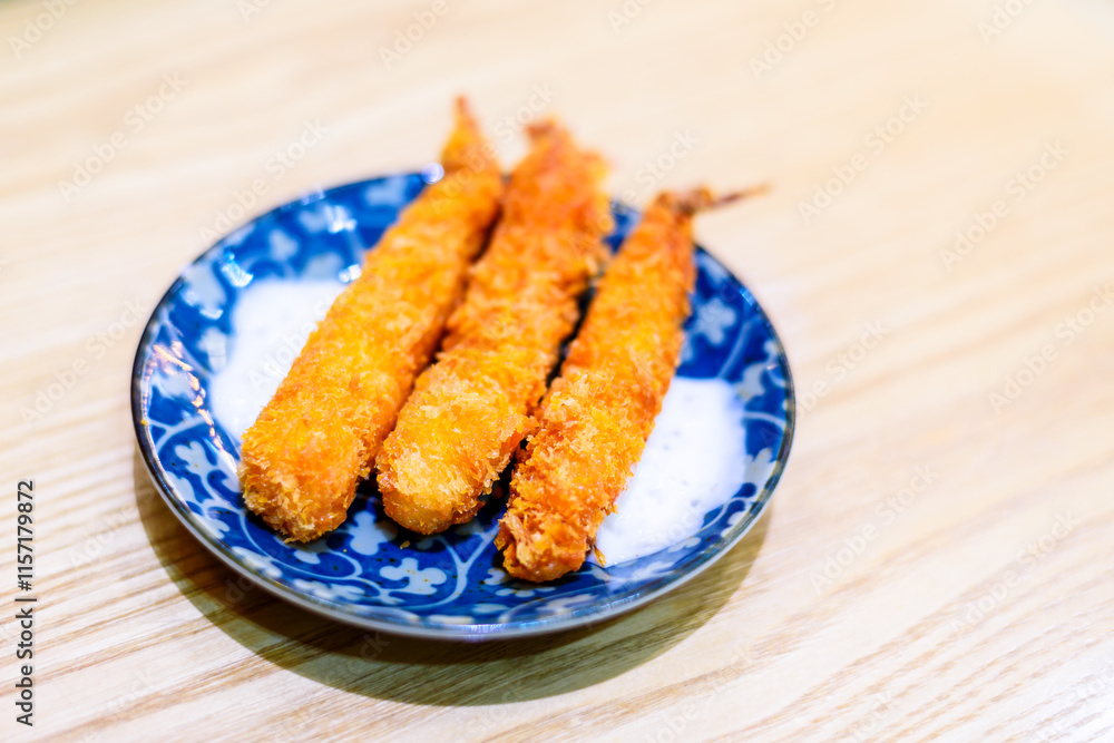 Golden Crispy Breaded Shrimp on Traditional Blue and White Porcelain Plate Golden Crispy Breaded Shrimp on Traditional Blue and White Porcelain Plate