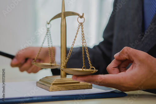 A dark-skinned Asian lawyer, dressed in professional attireon. provide legal advice, preparing cases in law office.