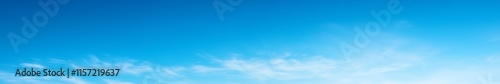 Serene gradient blue sky with few scattered clouds, creating a calm and tranquil atmosphere, perfect as a background for design projects and presentations.