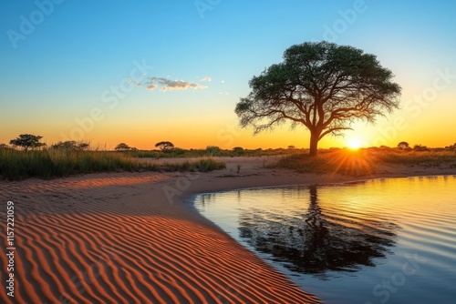 As the sun sets, its golden rays reflect in a tranquil desert oasis pond, near a solitary tree, embodying serenity, beauty and a sense of timelessness. photo