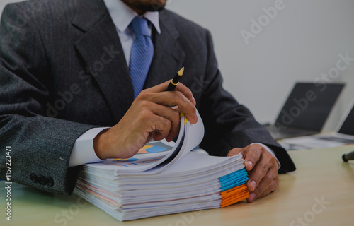 A dark-skinned Asian lawyer, dressed in professional attireon. provide legal advice, preparing cases in law office.