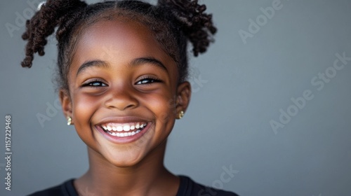 Young girl with beautiful smile poses against a neutral background in a vibrant expression of joy and happiness captured in a close-up portrait