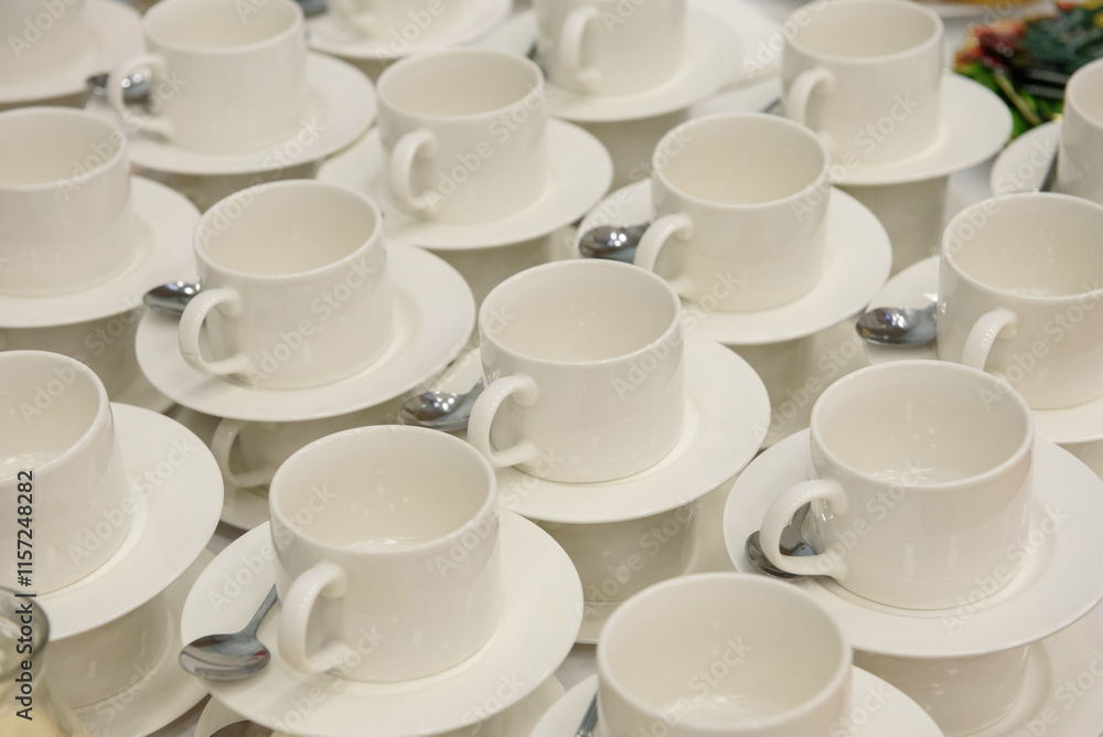 a set of white porcelain cups and saucers with metal spoons a set of white porcelain cups and saucers with metal spoons