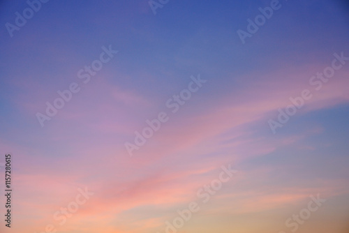 Early morning light sky before sunrise. Soft purple, pink and orange light on the horizon. Empty natural sky with colorful pastel tone colors for background. 
