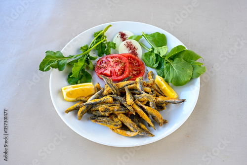 Fried Anchovies (Turkish Name: Hamsi Tava) .Hamsi, istavrit, sardalya tava. Balik kizartma. Izgara cipura levrek, palamut  yesil salata. photo