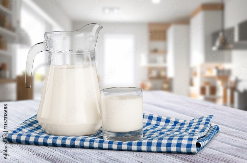 Tasty fresh milk into glass at light kitchen Tasty fresh milk into glass at light kitchen