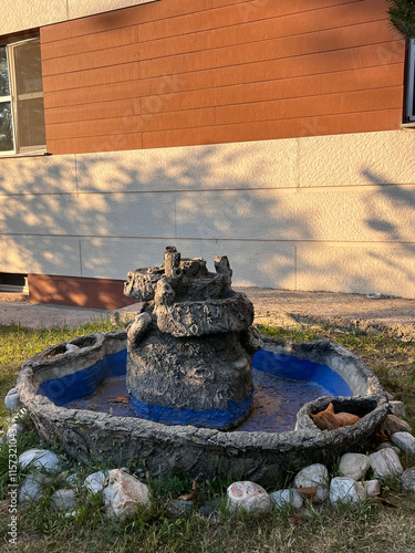 cat sleeping next to the statue photo